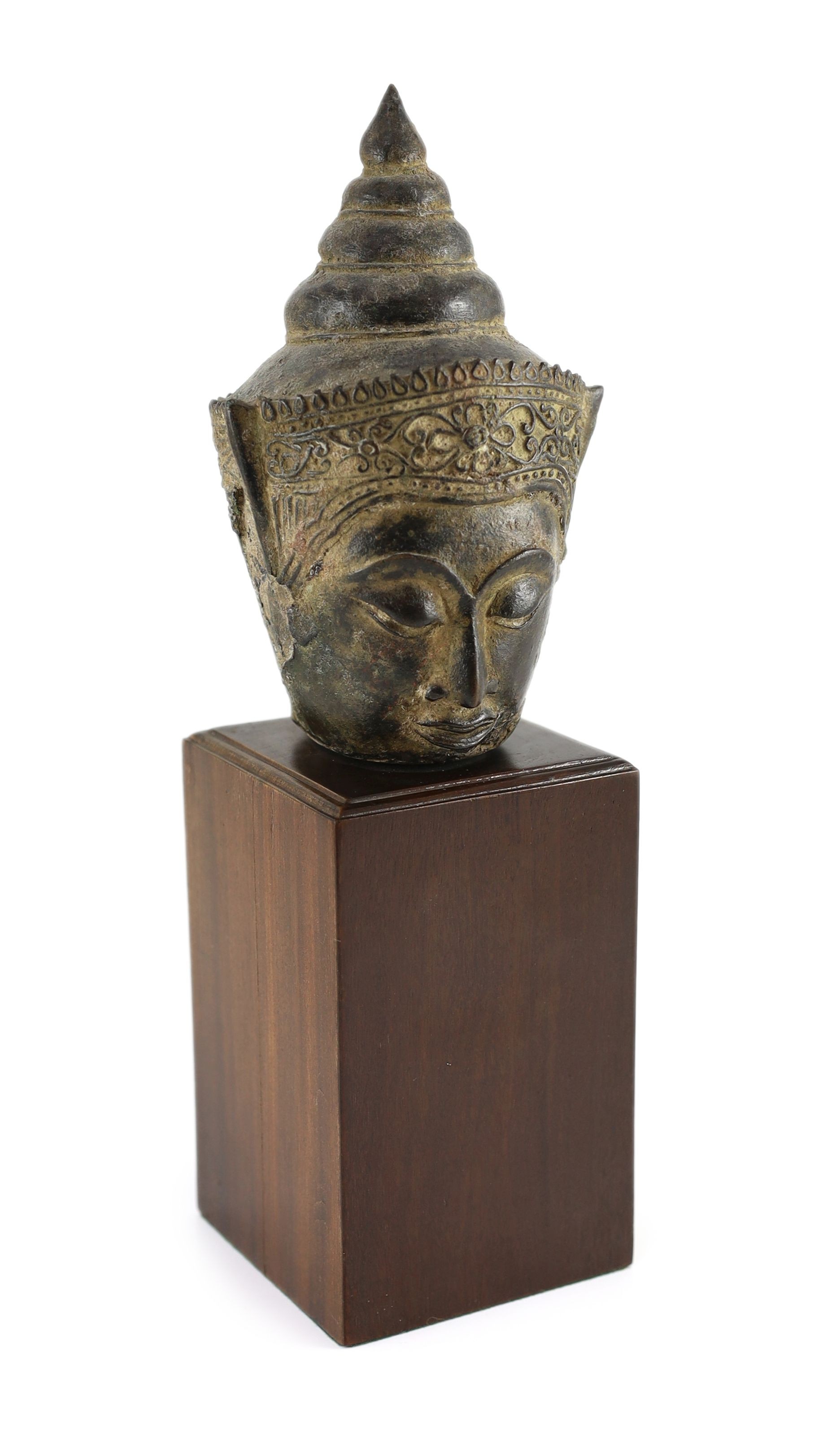 A Thai bronze crowned head of Buddha, 16th/17th century, 18cm high, excluding modern wood stand, ears lacking